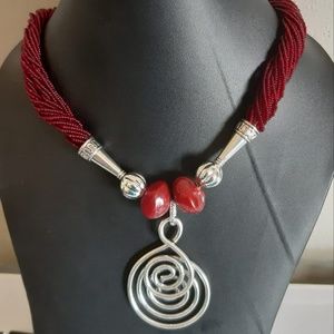 Red necklace with silver pendant